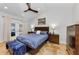 Comfortable main bedroom featuring a ceiling fan, ensuite access, and exterior access to the backyard at 13544 Avista Dr, Tampa, FL 33624