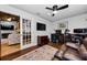 Inviting home office featuring a ceiling fan, hardwood floors, and a sliding door at 13544 Avista Dr, Tampa, FL 33624