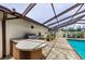 Well-equipped outdoor kitchen area, complete with a grill, sink, and countertop space, adjacent to the pool at 13544 Avista Dr, Tampa, FL 33624