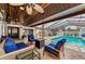 Inviting covered patio with comfortable seating, ceiling fans, and a view of the sparkling pool at 13544 Avista Dr, Tampa, FL 33624