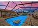 Beautiful enclosed pool area, complete with outdoor kitchen and lounge seating at 13544 Avista Dr, Tampa, FL 33624