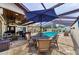 A beautiful outdoor area with a pool, outdoor dining, and kitchen for backyard enjoyment at 13544 Avista Dr, Tampa, FL 33624