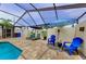 Inviting screened-in pool area with lounge chairs, umbrellas, and ample space for relaxation and entertainment at 13544 Avista Dr, Tampa, FL 33624