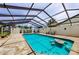 Beautiful screened-in pool with a swim-up table and plenty of space for seating and lounging by the pool at 13544 Avista Dr, Tampa, FL 33624