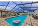 Gorgeous screened-in pool featuring outdoor kitchen with a grill and lots of space for outdoor lounging at 13544 Avista Dr, Tampa, FL 33624