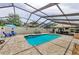 Stunning screened-in pool with outdoor seating, a swim-up bar and lots of lounging space for homeowners and guests at 13544 Avista Dr, Tampa, FL 33624