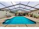 Inviting swimming pool, surrounded by a screened enclosure, offers privacy and protection from the elements at 13544 Avista Dr, Tampa, FL 33624