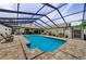 Large, screened-in swimming pool provides a relaxing outdoor space with ample seating and entertaining areas at 13544 Avista Dr, Tampa, FL 33624