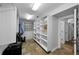 Spacious walk-in closet featuring custom shelving and tiled floors, offering ample storage at 13544 Avista Dr, Tampa, FL 33624