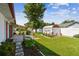 Expansive backyard with a storage shed, lush lawn, patio, and privacy fence at 1436 Santa Clara Dr, Dunedin, FL 34698