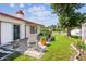 Inviting backyard with a patio, seating area, lush lawn, and mature trees at 1436 Santa Clara Dr, Dunedin, FL 34698