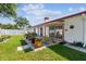 Well-maintained backyard with a patio, landscaped garden, and privacy fence at 1436 Santa Clara Dr, Dunedin, FL 34698
