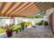 Charming backyard with a retractable awning, lush lawn, privacy fence, and seating area at 1436 Santa Clara Dr, Dunedin, FL 34698