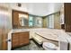 Elegant bathroom with a deep soaking tub, stylish vanity, and unique stained glass window at 1436 Santa Clara Dr, Dunedin, FL 34698