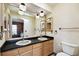 Bathroom with dual sinks, updated fixtures, and vanity lighting at 1436 Santa Clara Dr, Dunedin, FL 34698
