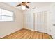Cozy bedroom featuring two closets, a ceiling fan, and wood flooring at 1436 Santa Clara Dr, Dunedin, FL 34698