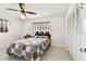 Bright bedroom featuring a ceiling fan, large closet, and a window with natural light at 1436 Santa Clara Dr, Dunedin, FL 34698