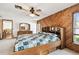 Bedroom featuring wood accent wall, ceiling fan, and natural light at 1436 Santa Clara Dr, Dunedin, FL 34698