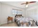 Comfortable bedroom with a ceiling fan, window blinds, and closet for ample storage at 1436 Santa Clara Dr, Dunedin, FL 34698