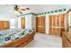 Bedroom with patterned wallpaper, ceiling fan, and closet space at 1436 Santa Clara Dr, Dunedin, FL 34698