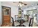 Cozy dining area featuring a glass table, decorative wall accents, and views into the living spaces at 1436 Santa Clara Dr, Dunedin, FL 34698