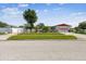 Traditional single Gathering home featuring a fenced lawn, mature trees, and well manicured landscaping at 1436 Santa Clara Dr, Dunedin, FL 34698