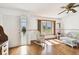Bright living space featuring hardwood floors, a large lattice window, and comfortable wicker seating at 1436 Santa Clara Dr, Dunedin, FL 34698