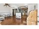 Open living area with gleaming hardwood floors, seamlessly flowing into adjacent kitchen at 1436 Santa Clara Dr, Dunedin, FL 34698