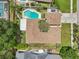Aerial shot shows the property with a private backyard oasis, featuring a sparkling pool and well-kept lawn at 15005 Roundup Dr, Tampa, FL 33624