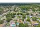 A residential neighborhood with mature trees, manicured lawns, and a serene pond at 15005 Roundup Dr, Tampa, FL 33624