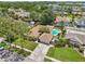 Wide aerial of home and surrounding neighborhood with mature trees and lawns at 15005 Roundup Dr, Tampa, FL 33624
