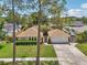 Aerial front view of home featuring lush lawn and a driveway at 15005 Roundup Dr, Tampa, FL 33624
