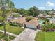 Aerial view featuring home, large driveway, and spacious lawn at 15005 Roundup Dr, Tampa, FL 33624