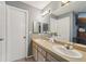 Bathroom featuring double sinks, ample counter space, and a large mirror at 15005 Roundup Dr, Tampa, FL 33624