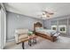 Bright bedroom with a ceiling fan, a seating area, and large windows for natural light at 15005 Roundup Dr, Tampa, FL 33624
