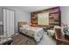 Cozy bedroom featuring natural light and rustic accent wall at 15005 Roundup Dr, Tampa, FL 33624
