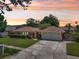 Charming single-story home with well-manicured lawn, lush landscaping, and a two-car garage at 15005 Roundup Dr, Tampa, FL 33624