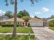 Charming single-story home with well-manicured lawn and mature landscaping at 15005 Roundup Dr, Tampa, FL 33624