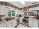 Updated kitchen with stainless steel appliances, ample counter space, and open to the dining area at 15005 Roundup Dr, Tampa, FL 33624