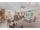 Comfortable living room featuring neutral tones, ceiling fan, large windows and an open floor plan at 15005 Roundup Dr, Tampa, FL 33624