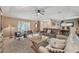 Spacious living room with comfortable seating, a ceiling fan, and an open floor plan at 15005 Roundup Dr, Tampa, FL 33624