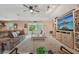 Comfortable living room with a large TV, ceiling fan, and sliding glass doors to the outside at 15005 Roundup Dr, Tampa, FL 33624