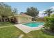 Backyard view of pool and patio area with lush green landscaping at 15005 Roundup Dr, Tampa, FL 33624