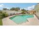 Inviting in-ground pool with clear water, surrounded by a patio and lush landscaping at 15005 Roundup Dr, Tampa, FL 33624