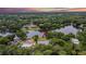 An aerial view showcases the property with lake access, nestled among lush greenery and serene surroundings at 16112 N 15Th St, Lutz, FL 33549