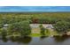Aerial view of lakefront property with trees and a dock at 16112 N 15Th St, Lutz, FL 33549