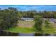 Aerial view of the home with lake frontage, spacious backyard, and mature trees at 16112 N 15Th St, Lutz, FL 33549