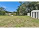 Lush backyard with a pond and a shed near the house at 16112 N 15Th St, Lutz, FL 33549