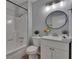 Well-lit bathroom features modern fixtures, a shower-tub combination, and a vanity at 16112 N 15Th St, Lutz, FL 33549
