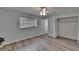 Bright bedroom features wood floors, a ceiling fan, and a closet for ample storage at 16112 N 15Th St, Lutz, FL 33549
